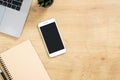 Stylish office table desk. Workspace with laptop, coffee cup, paper notebook, pen, succulent plant on wooden background. Minimal Royalty Free Stock Photo