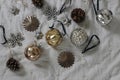 Stylish old Christmas ornaments. Vintage glass baubles, balls. Pine cones on grey muslin blanket, throw. Decorative Royalty Free Stock Photo