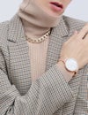 Stylish paris Lady. Details of everyday look. Casual beige checkered jacket and accessories watch and chain. Trendy Minimalistic