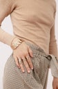 Stylish paris Lady. Details of everyday look. Casual beige checkered paints and accessories jewelry rings and bracelets. Trendy