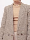 Stylish paris model. Details of everyday look. Casual beige checkered jacket and accessories chain.Trendy Minimalistic style.