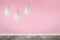 Pendant lamps hanging near pink wall in room Royalty Free Stock Photo