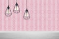 Stylish pendant lamps hanging near wall in room Royalty Free Stock Photo