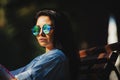 Stylish photo of woman in round sunglasses.