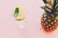 Stylish pineapple and mojito cocktail drink on trendy pink paper