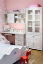 Stylish pink bedroom for girl with bed