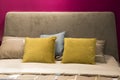 stylish pink bedroom interior design with decorate pillows on grey velvet bed Royalty Free Stock Photo