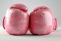 Stylish Pink boxing gloves on a white background. Concept of femininity in sports, fashionable athletic equipment, and