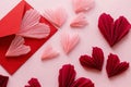 Stylish pink hearts and red envelope flat lay on pink paper background. Happy Valentine`s day! Modern Valentines day composition.