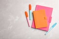 Stylish pink and orange notebooks, pens on table, flat lay. Space for text Royalty Free Stock Photo