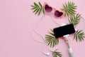 Stylish pink sunglasses, phone on selfie stick, headphones, and Royalty Free Stock Photo