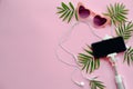 Stylish pink sunglasses, phone on selfie stick, headphones, and Royalty Free Stock Photo