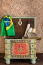 Stylish pirate chest with travel hat, Brazilian flag and old maps. Adventure and travel concept