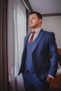 A stylish portrait of the groom preparing for the wedding ceremony