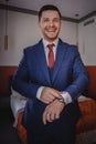 A stylish portrait of the groom preparing for the wedding ceremony