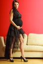 Stylish pregnant woman in black.