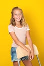 Stylish pretty teen girl posing over yellow background. Summer fashion. Healthy perfekt skin. Beauty smile, white perfekt teeth.