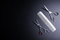 Stylish Professional Barber Scissors and white comb on black background. Hairdresser salon concept, Hairdressing Set. Haircut