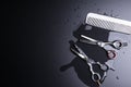 Stylish Professional Barber Scissors and white comb on black background. Hairdresser salon concept, Hairdressing Set. Haircut Royalty Free Stock Photo