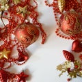 Red balls for the Christmas tree and beads for decoration for winter holidays on a white background. preparation for Christmas and Royalty Free Stock Photo