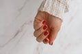 Stylish red female nails. Modern Beautiful manicure. Autumn winter nail design concept of beauty treatment. Gel nails Royalty Free Stock Photo