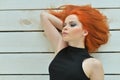 Portrait of stylish redhead young woman posing