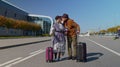 Stylish retired family couple granny grandfather walking with luggage suitcase bags to airport hall Royalty Free Stock Photo