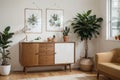 Stylish and retro composition of living room with design wooden retro commode, clock, a lot of plants and elegant accessories. Mod