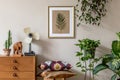 Stylish retro home staging of living room with gold mock up poster frame.