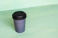 Stylish reusable eco-friendly bamboo cup on mint green background. Royalty Free Stock Photo