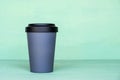 Stylish reusable eco-friendly bamboo cup on mint green background Royalty Free Stock Photo