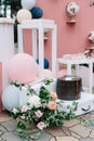 Stylish romantic details and wedding decoration with balloons, flowers. Photo zone on pink travel-style background