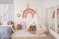 Stylish room with bed and teepee tent for kids. Interior design Royalty Free Stock Photo