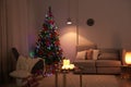 Stylish room interior with candles and Christmas tree Royalty Free Stock Photo