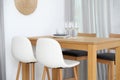 Stylish room interior with dining table and bar stools near wall Royalty Free Stock Photo