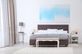 Stylish room interior with large comfortable bed Royalty Free Stock Photo