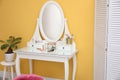 Stylish room interior with modern dressing table near wall Royalty Free Stock Photo