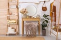 Stylish room interior with modern wooden dressing table near white wall Royalty Free Stock Photo