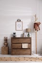 Stylish room interior with wooden chest of drawers near wall Royalty Free Stock Photo