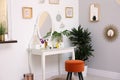 Stylish room with modern dressing table near light wall Royalty Free Stock Photo