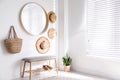 Stylish round mirror hanging on white wall in room Royalty Free Stock Photo