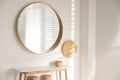 Stylish round mirror hanging on white wall in room Royalty Free Stock Photo