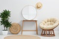 Stylish round mirror near wall in room