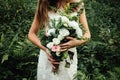 Stylish rustic bouquet in the hand of gorgeous boho bride on the