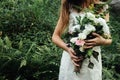 Stylish rustic bouquet in the hand of gorgeous boho bride on the