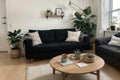 Stylish Scandic living room interior - sofa, armchair, coffee table, plants in pots, lamp, home decorations. Cozy Autumn. Modern c