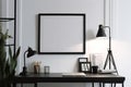 Minimalistic style interior design of working area, white wall, black picture frame Royalty Free Stock Photo