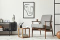 Stylish scandinavian composition of living room with design armchair, black mock up poster frame, commode, wooden stool, plant.