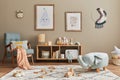 Stylish scandinavian kid room interior with toys, teddy bear, plush animal toys, mint armchair, furniture, decoration. Royalty Free Stock Photo