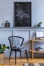 Stylish scandinavian living room interior with design black chair, wooden console, plants, books, decoration, mock up poster map Royalty Free Stock Photo